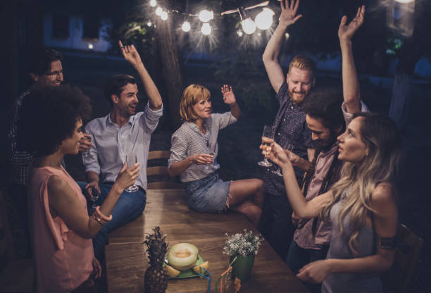 istock Large group of friends having fun while dancing and singing on a night party. 950604666