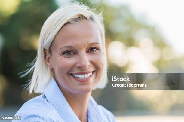Happy Mature Woman Smiling Stock Photo - Download Image Now - Human Face, Mature Women, One Woman Only