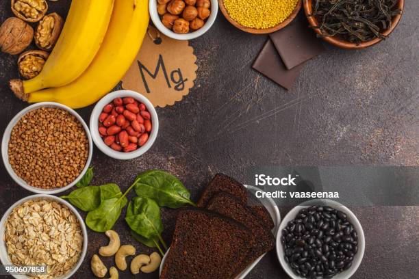 Healthy Food Nutrition Dieting Concept Assortment Of High Magnesium Sources Banana Chocolate Spinach Buckwheat Nuts Beans Oat Dark Background Copy Space Stock Photo - Download Image Now