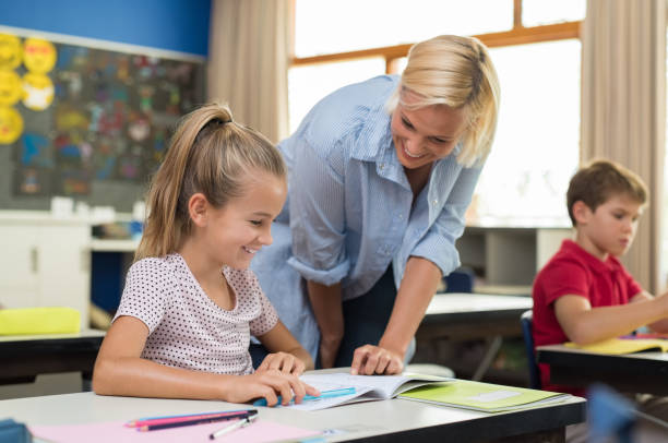 istock Teacher helping girl to study 950607966