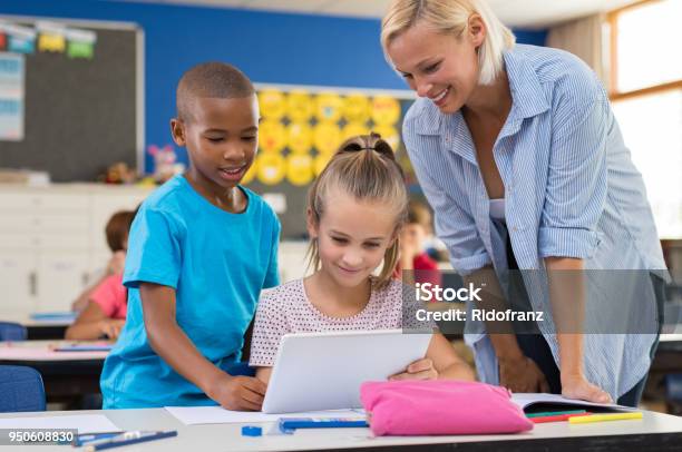 Kids Using Digital Tablet In Classroom Stock Photo - Download Image Now - Teacher, Digital Tablet, Child