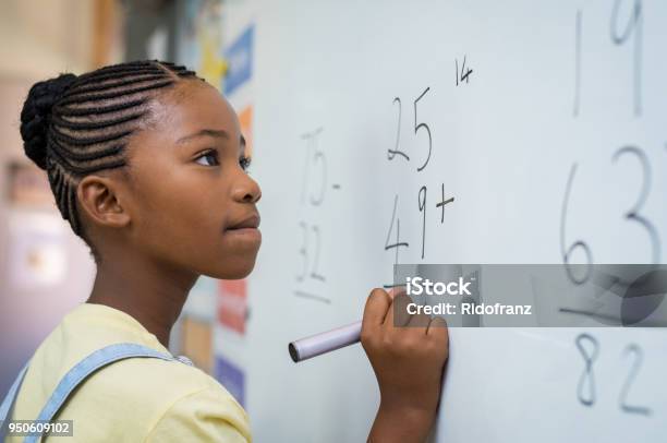 Girl Solving Mathematical Addition Stock Photo - Download Image Now - Mathematics, Mathematical Symbol, Child