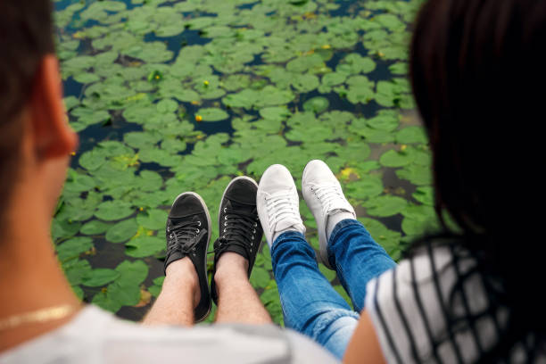 istock Male and female legs during a date 950612428