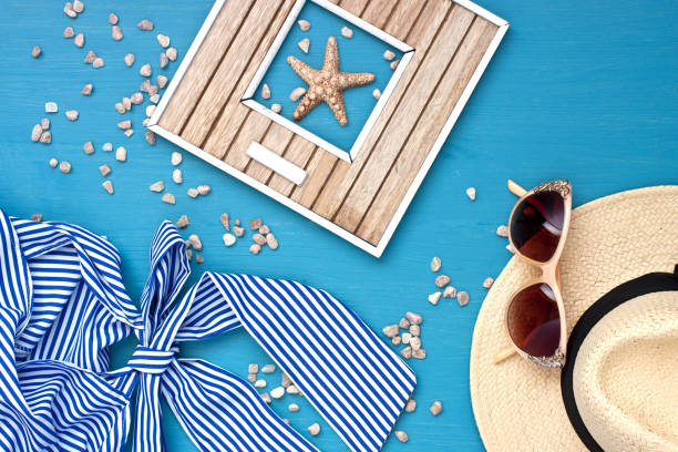 Sunglasses and wicker hat on table
