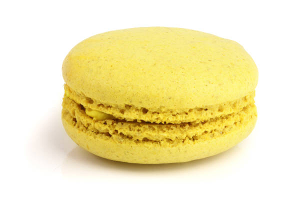 istock yellow macaron isolated on white background closeup 950613332