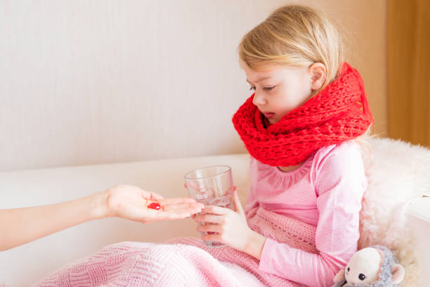 istock Young girl taking medicine pill 950614742