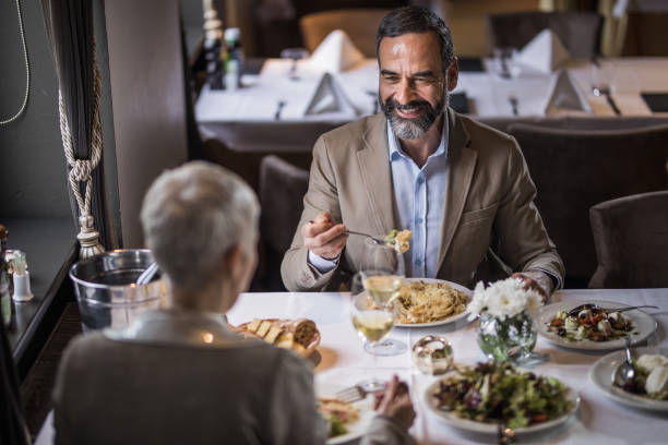 istock Happy mature couple talking during lunch time in a restaurant. 950615222