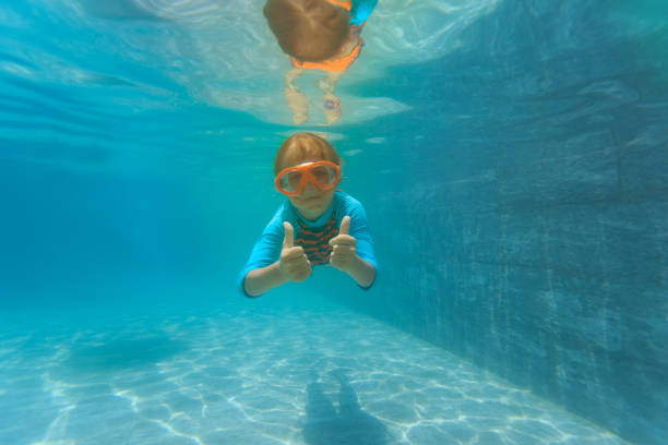istock happy boy swim underwater with thumbs up 950619050