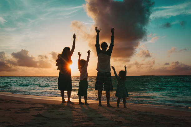 istock happy family with kids having fun at sunset 950619598