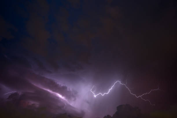 istock Stroke of lightning with storm clouds and golden sunset light 950623490