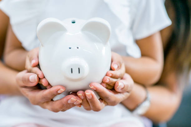 istock Holding A Piggy Bank 950624942