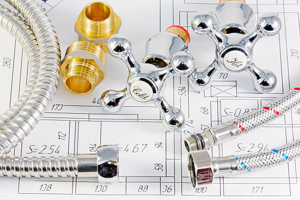 istock Close-up of plumbing technology over blueprints 95062619
