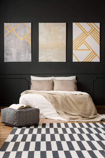 istock Paintings on black wall in bedroom 950629426