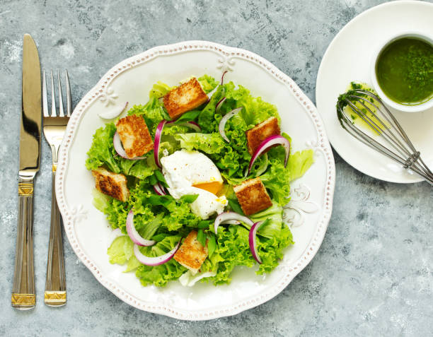 istock Spring salad with poached egg and crispy croutons. View from above. 950630416