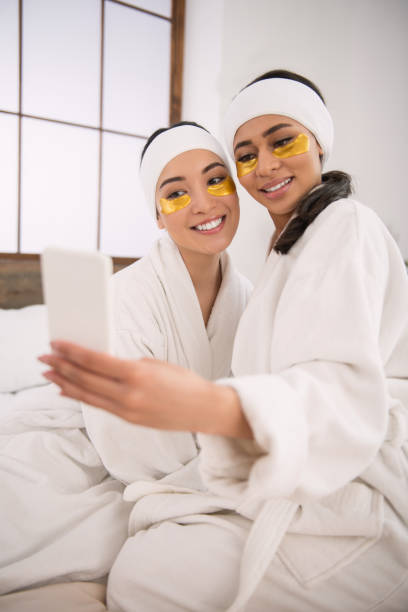 istock Positive lesbian couple taking photos 950634048