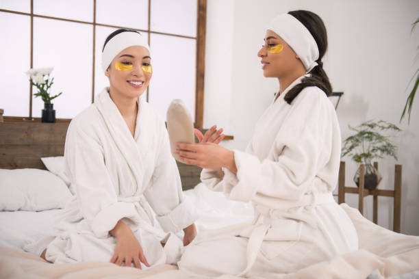 istock Nice pleasant woman holding body lotion 950634274