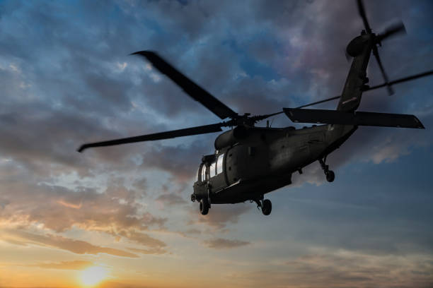 istock Military Helicopter flaying at sunset 950634398