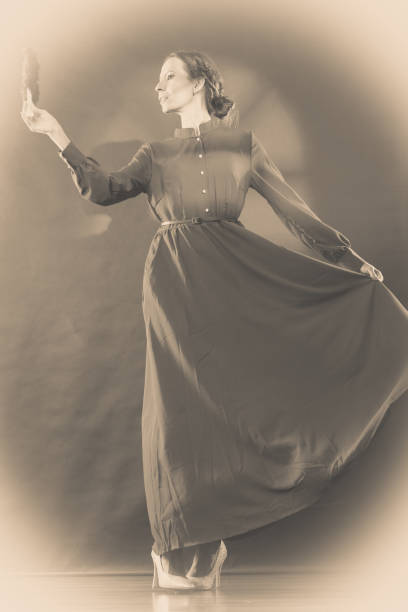 istock Vintage lady with feather fan on dark 950634634