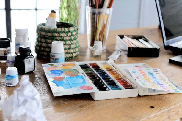 istock Conceptual image of graphic designer workplace, with a pen tablet, a computer and some color swatches 950638058
