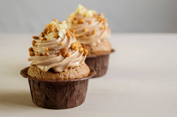 istock Chocolate cupcake with cream on dark background. 950638122