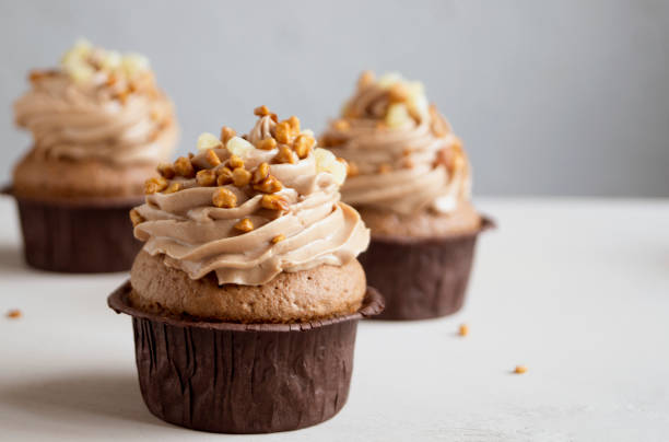 istock Chocolate cupcake with cream on dark background. 950639234