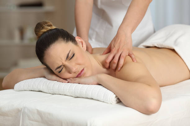 istock Woman suffering receiving a massage 950639480