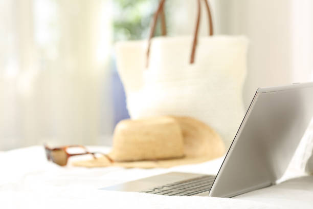 istock Vacation objects and laptop on an bed in an hotel room 950639508