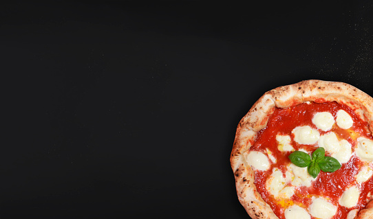 Neapolitan pizza on a black background, ideal for banners to print or for websites, pizza vesuvius, naples. The real Italian pizza.