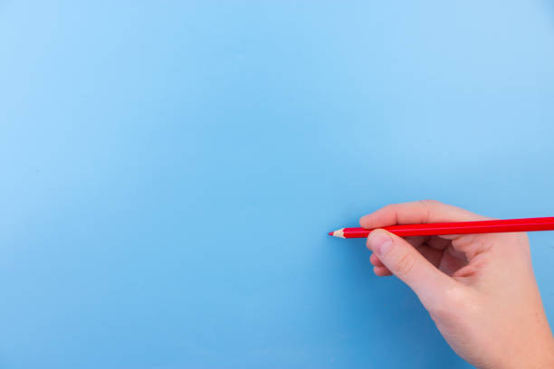 istock Female hand is ready for drawing with red marker 950646218