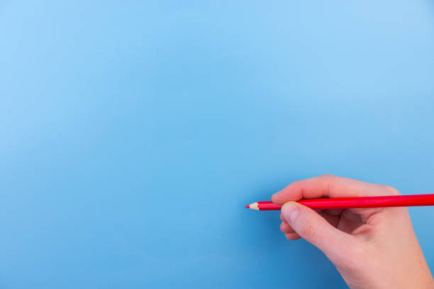 istock Female hand is ready for drawing with red marker 950646222