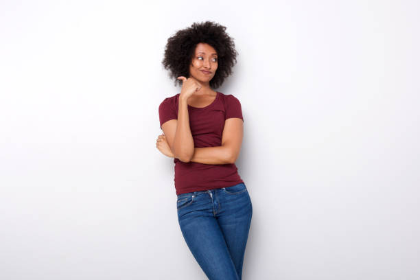 istock upset young african woman pointing backwards with her thumb on white background 950646416