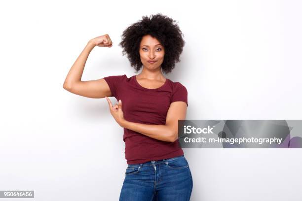 Fit Young African Woman Pointing At Arm Muscles On White Background Stock Photo - Download Image Now