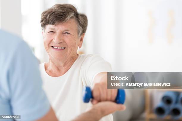 Senior Woman Exercising With Weights Stock Photo - Download Image Now - Senior Adult, Recovery, Stroke - Illness