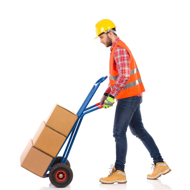 istock Manual Worker Is Walking And Pushing Hand Truck 950659852