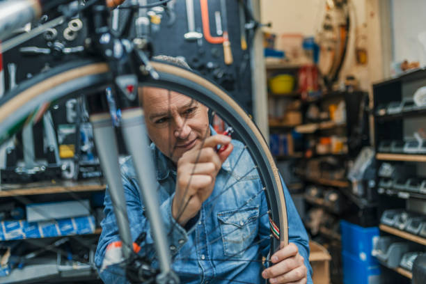 istock Technician fixing bicycle in repair shop 950659910