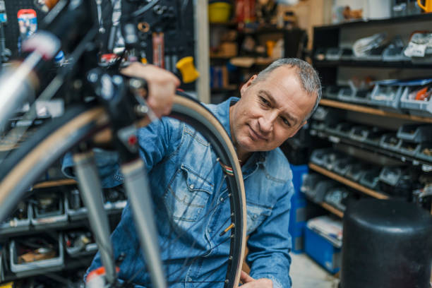 istock Man bicycle mechanic repairing bicycles 950661270