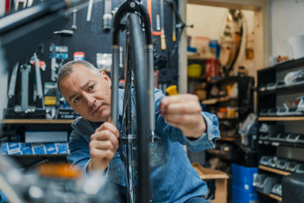 istock Bicycle mechanic in a workshop in the repair process 950669304