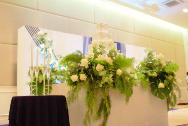 istock White Rose Bouquet Candle Holder and Wedding Cake on Wedding Stage 950670440