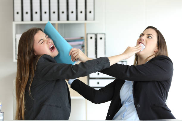 Two angry executives fighting at office Two angry executives fighting hitting with folders at office evil stock pictures, royalty-free photos & images