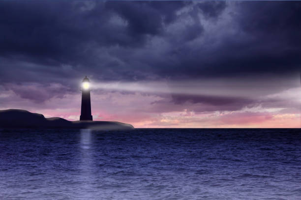 istock Lighthouse and seascape with dark clouds at night 950672382
