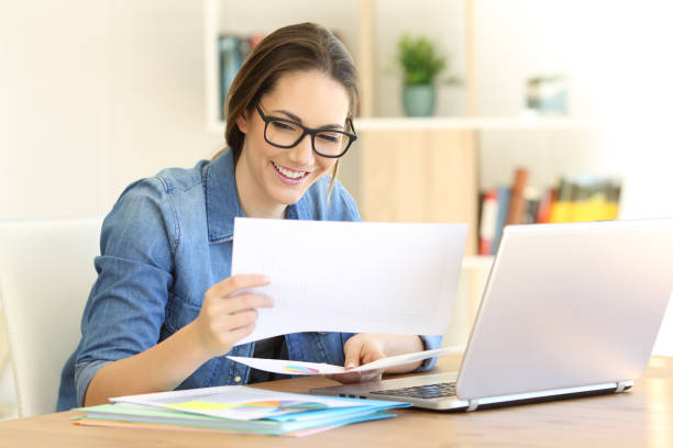 istock Happy self employed cheching files at home 950679438
