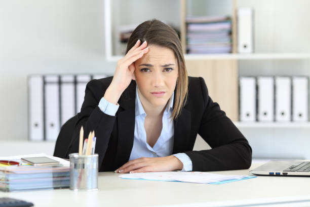istock Worried executive looking at camera at office 950679520