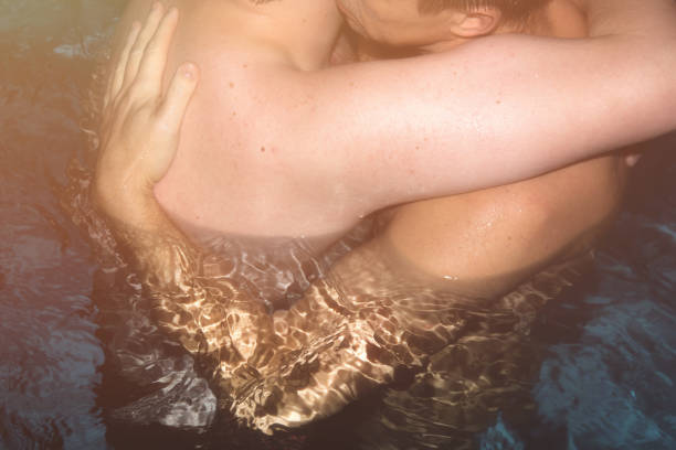 istock Two men in the pool. Love and romance. 950679536