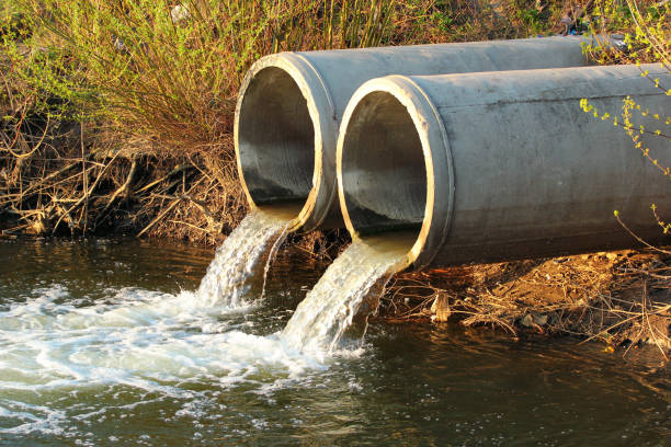 Discharge of sewage into a river stock photo