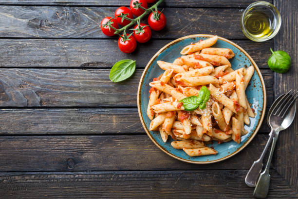 istock Penne pasta in tomato sauce 950679738