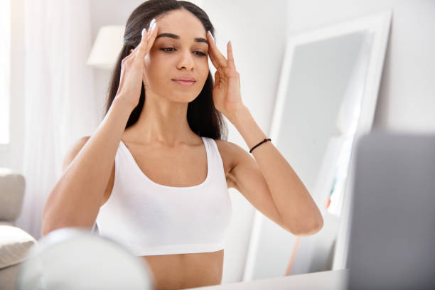 istock Beautiful woman watching facial massage tutorial 950679764
