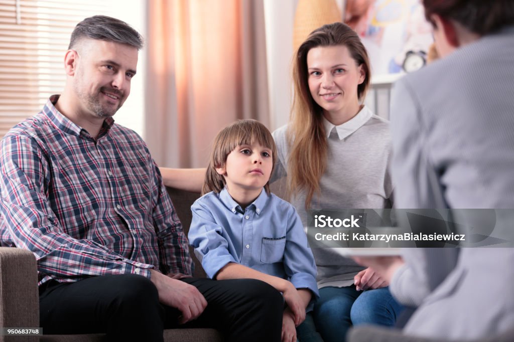 Happy marriage with son Happy marriage with son during meeting with counselor Family Stock Photo