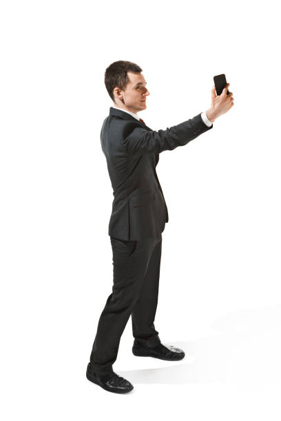 istock Happy businessman talking on the phone isolated over white background in studio shooting 950684746