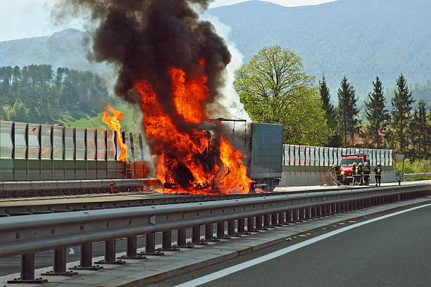 istock Truck on fire on a highway with firefighters approaching 95068533