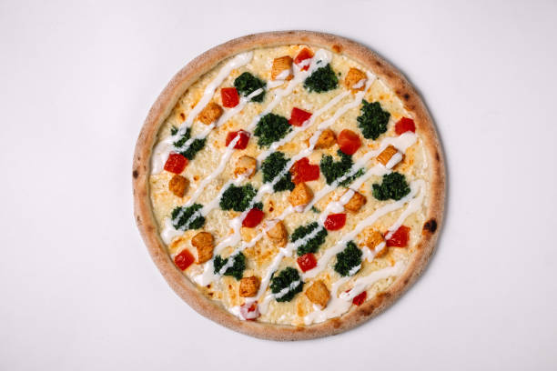istock Pizza with chicken, tomato and spinach on white. Top view 950689592